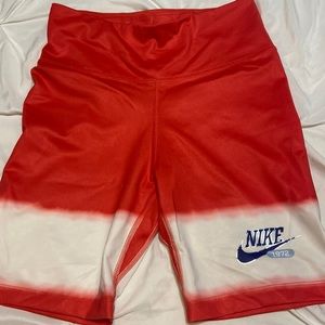 Womens Nike biker shorts. Reddish/orange color.